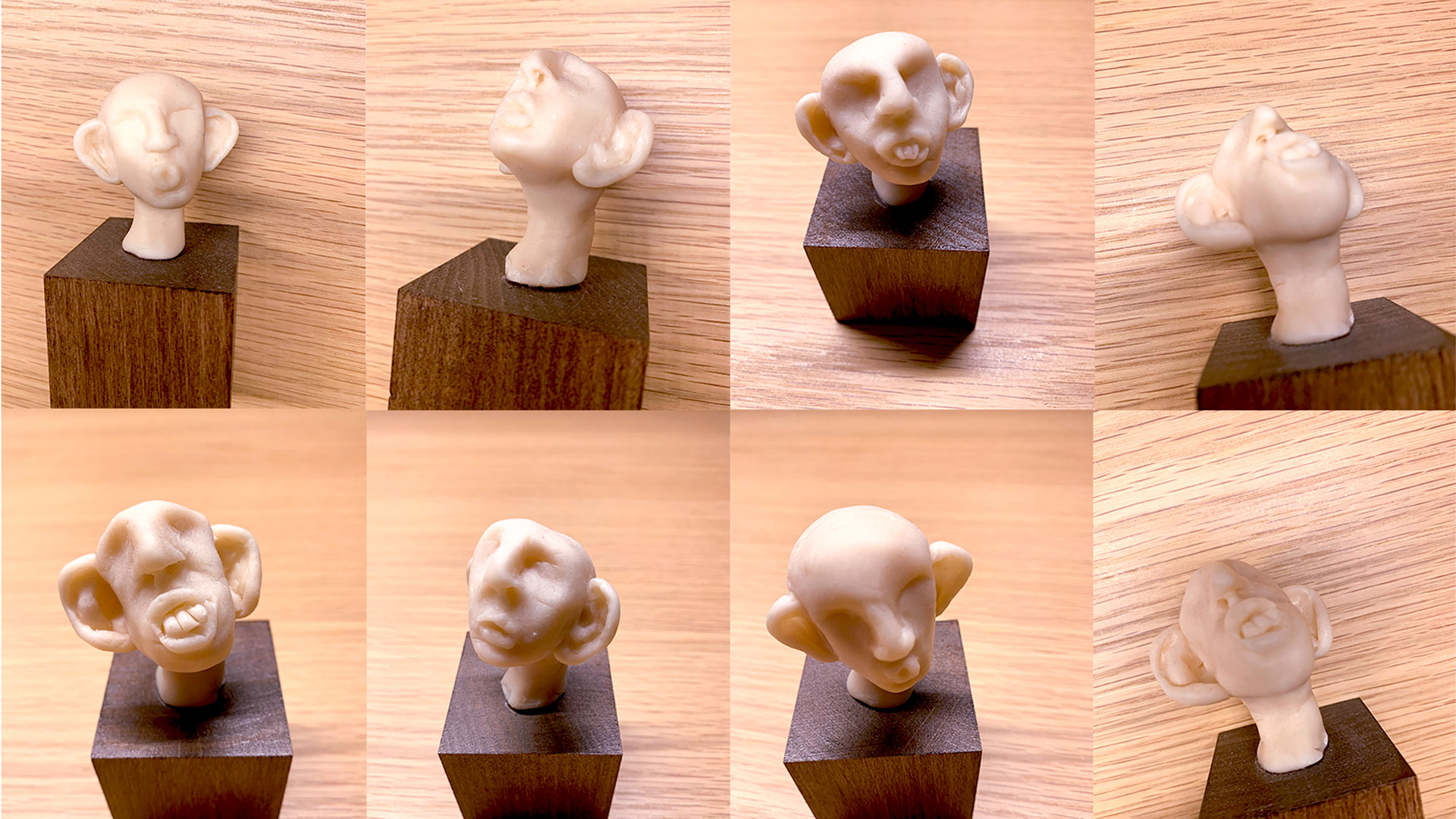 Neun Detailaufnahmen von Lauscher-Figuren mit grossen Ohren auf Holzsockeln, jede mit eigenem Gesichtsausdruck, vor Holzgrund.