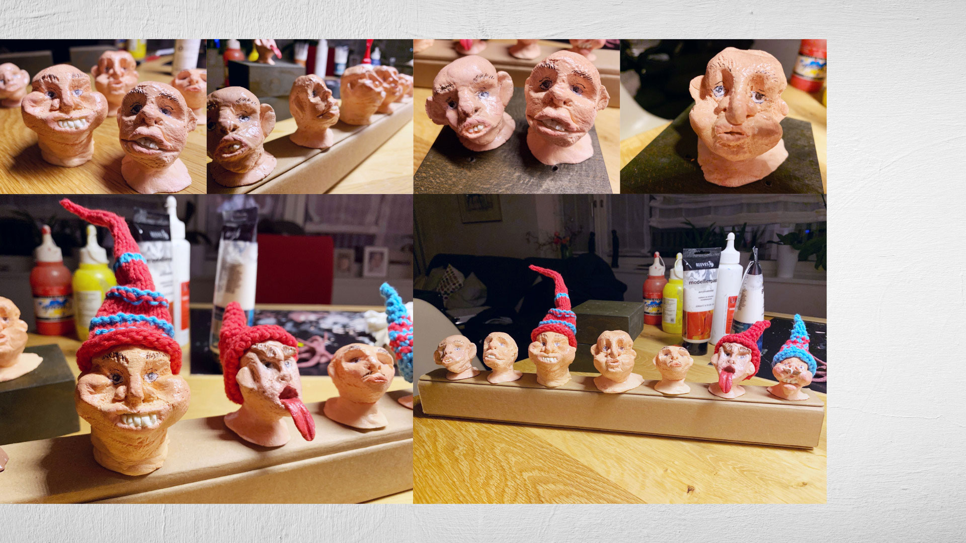 Prototyp‑Modelle für die Serie ‹Lauscher› von Heidrun Föhn: mehrere farbige Salzteigköpfe mit gestrickten Mützen, aufgereiht auf einem Tisch im Atelier, 2021.